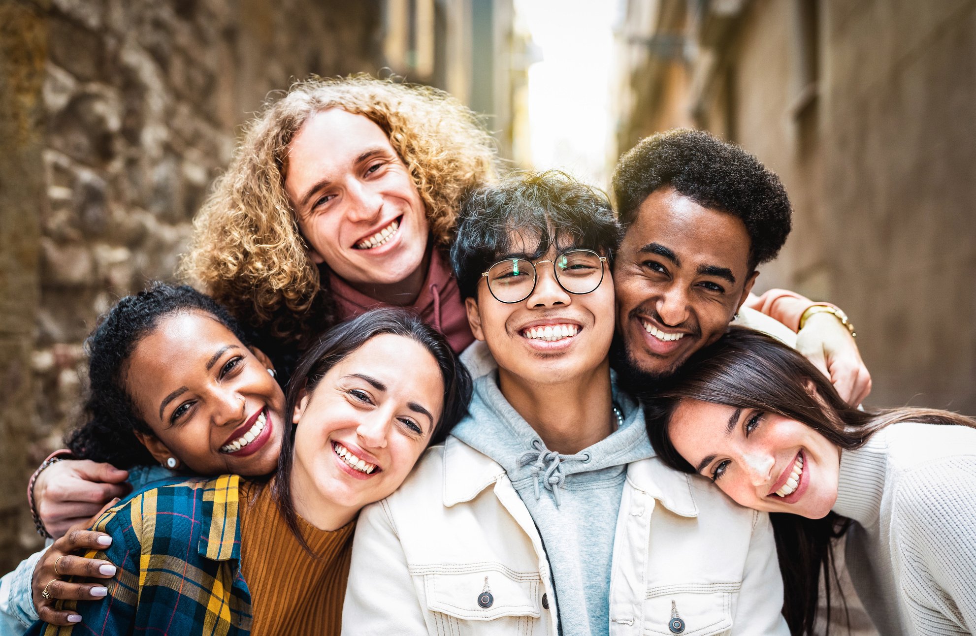 Multi racial guys and girls taking selfie outdoors with backligh